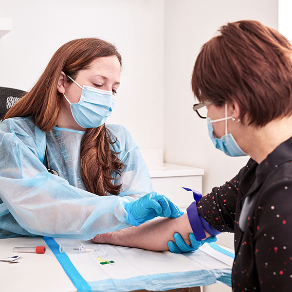 Andrée Charbonneau performing a blood draw from a patient at Santé Cannabis