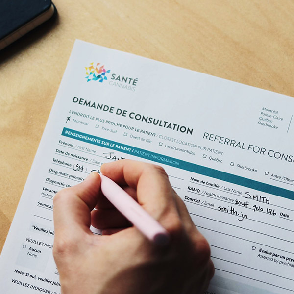 A patient filling out a referral form at Santé Cannabis