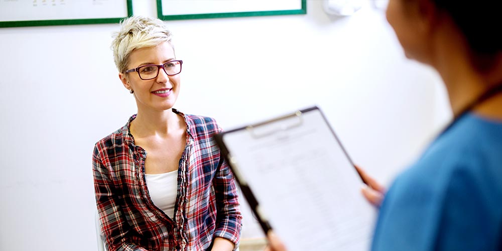 Non binary patient talking to doctor